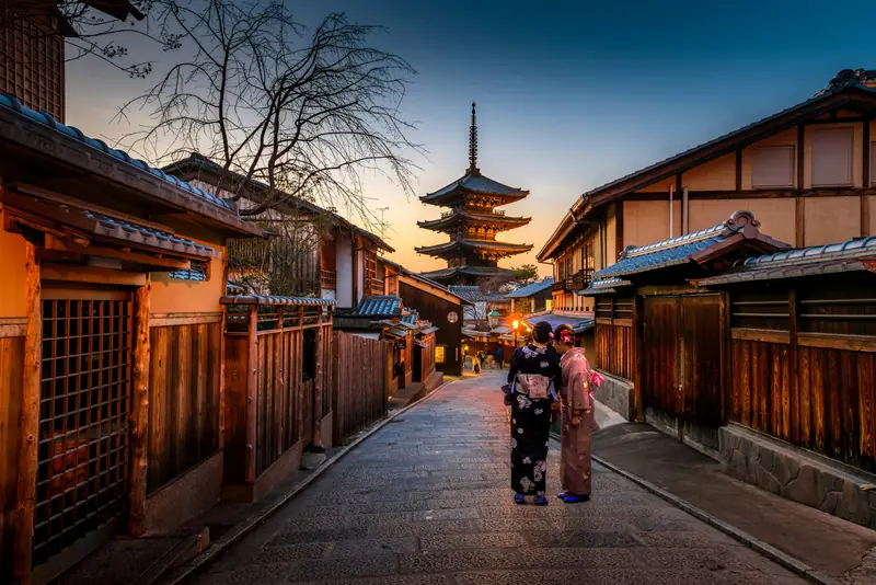 A lantern-lit street in Kyoto with a pagoda