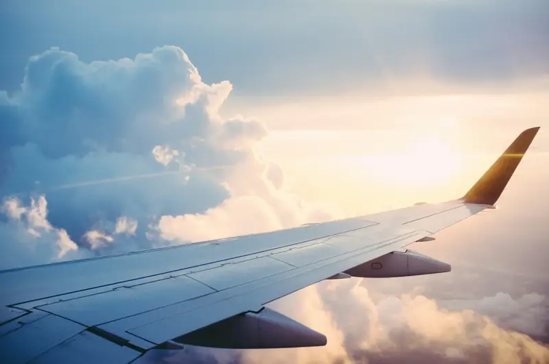 View over a plane wing above the clouds