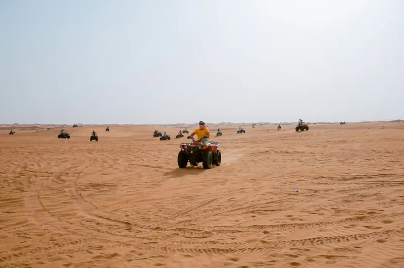 Quad bikes crossing the dunes outside Dubai