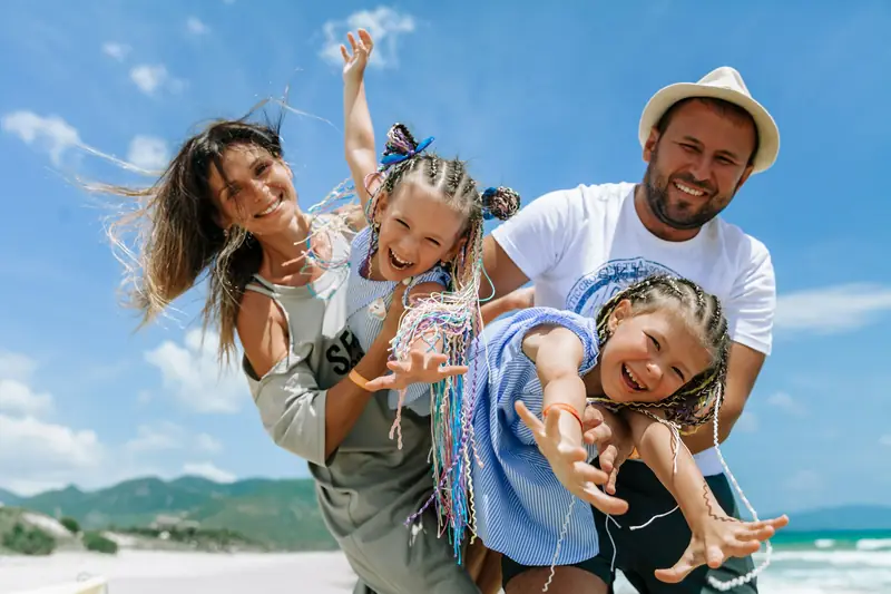 A happy family playing on a sunny beach